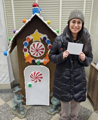 Marisa Pennington was the first place winner in the 18 and up division of the Lamb County Library’s Gingerbread House Contest. The winners were announced after the Lighted Christmas Parade on Friday at the Library’s Open House. (Staff Photo by Derek Lopez)