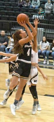 TAKING THE CONTACT — Sudan junior, Addison Boehning (4), absorbs contact from the Muleshoe defense, as she puts up a tough shot from the right side, during the first half of the Nettes’, 50-28, victory over the Muleshoe Lady Mules on the road on Monday. (Staff Photo by Derek Lopez)