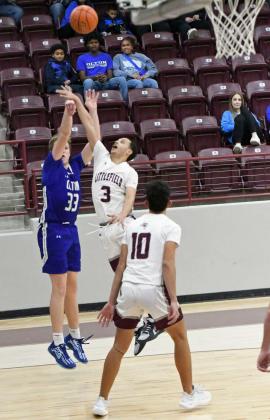 Olton’s Johnathan Cooper puts up a jumper from the right wing over Littlefield’s Ryan Williams, during their second round match-up at the Wildcat Classic last Friday. (Staff Photo by Derek Lopez)