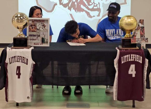Littlefield’s Kam McCarty, signed on the dotted line on Thursday to continue his basketball and academic career at Wayland Baptist University for the Pioneers. He signed during a small ceremony with his parents by his side, as well as teammates, classmates and coaches in attendance. (Staff Photo by Derek Lopez)