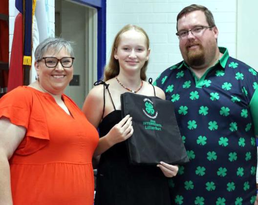 Lillian Burt, center, received the Rising Star Award and the Intermediate Outstanding Record Book at the 4-H Banquet held August 16,2025 in Olton, Texas. Presenting the awards were Kathy Lostroh and Brandon Albus. (Photo by Ann Reagan)