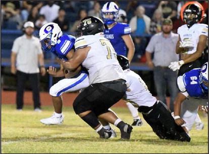 Sudan senior nose guard, Jon Conley (75), tackles, Olton junior running back, Isaiah Ruiz (9), during the fourth quarter of Friday’s game against the Mustangs, as Sudan fell to the Mustangs, 22-15, in their season-opener. (Staff Photo by Derek Lopez)