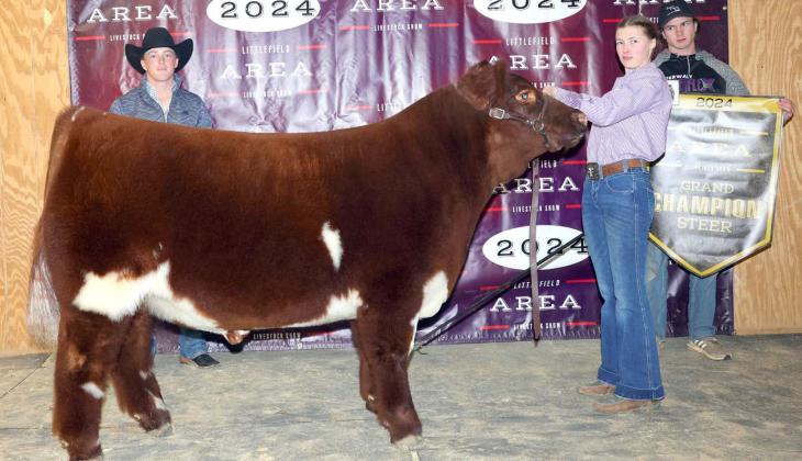Kauy Carr of Sudan 4-H won Grand Champion Goat at the Littlefield Area Junior Livestock Show on Friday at the Lamb County Ag Center. Shown with Judge Hadley Albracht. (Photo by MD Creations)