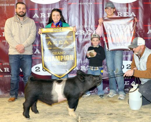Emry Humphreys of Sudan FFA won Grand Champion Swine at the Littlefield Area Junior Livestock Show on Friday at the Lamb County Ag Center. Shown with Judge Walker Hemphill. (Photo by MD Creations)