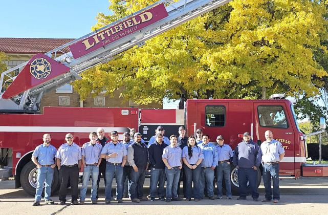 The Littlefield Volunteer Fire fighters pose for a picture with the new Quint Fire Truck, at the Littlefield Fire Department for the Dedication of the New Quint Fire Truck on Tuesday, Nov. 19th. (Staff Photo by Derek Lopez)