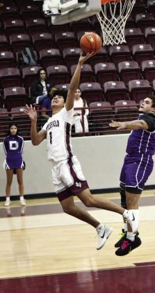 Littlefield junior, Jayden Barrio (1), gets to the basket for a tough lay-up, during the first half of the Wildcats’ district victory over Dimmitt on Tuesday at Wildcat Gym. (Staff Photo by Derek Lopez)