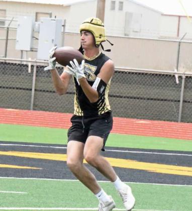 Kincaid Boehning catches a pass from quarterback, Caleb Groetken, for a solid gain, during their 7v7 match-up against Wink on Saturday in Sudan. (Staff Photo by Derek Lopez)