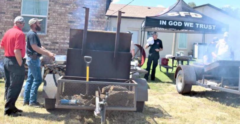Left to Right - Rd Gass, Dustin Provence and Mike Campbell are shown grilling the delicious burgers to serve at the Benefit for Sgt Shawn Wilson of Sudan. (Photo by Ann Reagan)