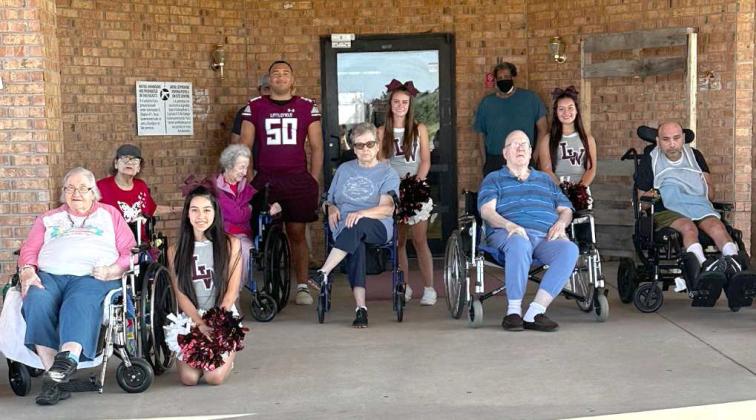 Arbor Grace Wellness Center residents, Lucretia Roach, Tommy Torres, Mary Tisdale, Peggy Seagroves, Jerry Cox, and Joe Gutierrez visit with some of the Wildcat football players and Cheerleaders during Homecoming week, Sept. 16 through the 20th. (Submitted Photo)