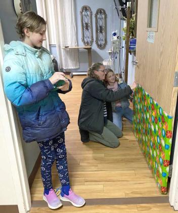 (Submitted Photo) Members of Littlefield 4-H decorated the doors at Lamb Healthcare Center, as part of their Service Project on December 10th.