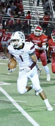 CATCH AND RUN – Littlefield senior wide receiver, Javen Jimenez (1), catches a pass from quarterback, Chip Green, before turning it up field for a solid gain in the second half of the Wildcats’, 33-14, victory over Denver City on the road on Friday night. (Staff Photo by Derek Lopez)