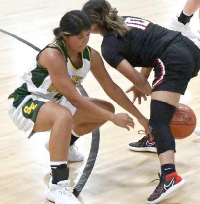 ACTIVE HANDS – Springlake-Earth senior, Mahalia Delgado (4), gets down and pokes the ball away from Lockney’s Arianna Villareal (10), during the second half of the Lady Wolverine’s loss to the Lady Horns on Tuesday during their season-opener. (Staff photo by Derek Lopez)