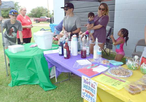 SNOW CONES AND SCHOOL SUPPLIES – Members of the Anton Volunteer Fire and Rescue serve up snow cones and other treats to beat the heat for the back to school bash held Saturday, Aug. 27. (Photo by Samantha Pontius)