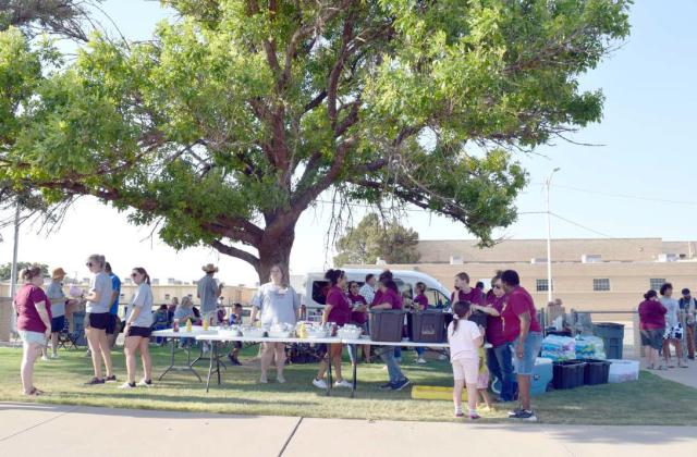 The Shade tree at the Primary School is a popular spot for the guests and staff at the Third Annual Back to School Family Cookout held at the Primary Playground on Monday, August 21, 2023. (Photo by Ann Reagan)
