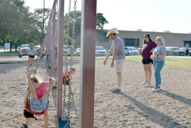 This Littlefield Primary family is just swinging at the Third Annual Primary Back to School Cookout social held at the Littlefield Primary School playground on Monday, August 21, 2023. (Photo by Ann Reagan)