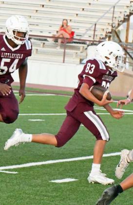 Littlefield’s Christian Mata (83), takes a carry up the middle rumbling his way into the endzone for a touchdown, during the second half of their, 44-6, victory on Thursday at Wildcat Stadium. (Staff Photo by Derek Lopez)