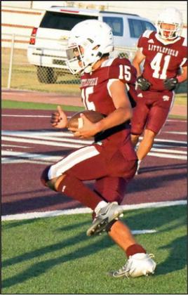 Littlefield’s Sammy Saenz (15), carries the ball into the endzone for a score, during the first half of their, 44-6, victory on Thursday at Wildcat Stadium. (Staff Photo by Derek Lopez)