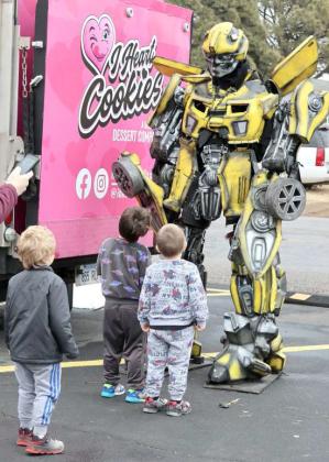 WOW!!! -- These youngsters are having fun meeting the Transformer character “Bumblebee” brought to the Food King of Littlefield parking lot by I-Heart Cookies of Lubbock on Tuesday January 23, 2024. (Photo by Ann Reagan)