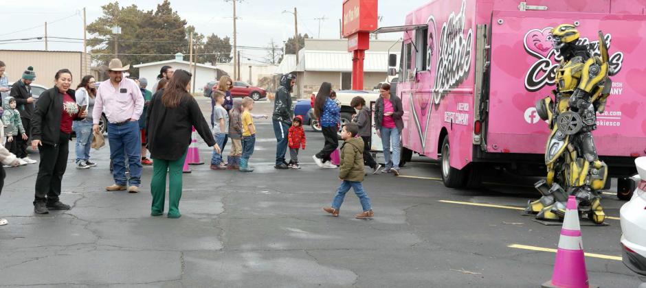 BUMBLEBEE -- A large after school crowd gathered at the Food King of Littlefield, Texas on Tuesday, January 23, 2024 to purchase specialty cookies by I Heart Cookies and interact with the Transformers character “Bumblebee” who was brought along for photo ops and to entertain the people waiting in line for cookies. (Photo by Ann Reagan)