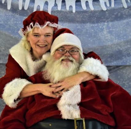 Special guests for Christmas Movie Night were Mr. and Mrs. Santa Clause who came by to take requests from the children at Our Place, during their Christmas Movie night on Friday. (Photo by Ann Reagan)