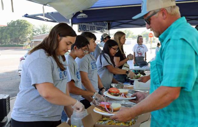 The Olton Volunteer Ambulance Association serving their Hamburger supper on Wednesday, the opening day of the 44th annual Sandhills Celebration. (Photo by Wesley Quigley)