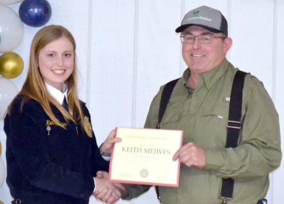 Littlefield FFA Chapter President, Kamryn Meiwes, presents Keith Meiwes with an Honorary FFA Degree.