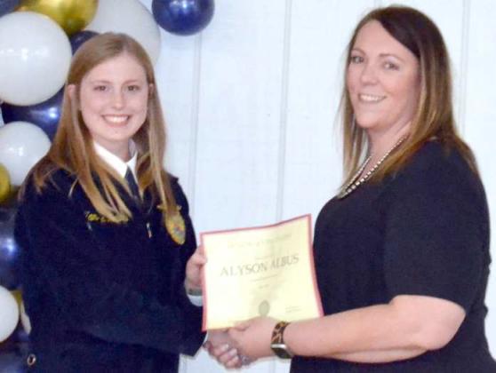 Littlefield FFA Chapter President, Kamryn Meiwes, presents Alyson Albus with an Honorary FFA Degree.
