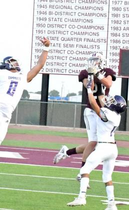 GOING UP AND GETTING IT – Littlefield senior, Chris Brown, make a big catch over two Dimmitt defenders to move the chains for the Wildcats, during their, 56-0, season-opening victory on Friday at Wildcat Stadium. (Staff Photo by Derek Lopez)