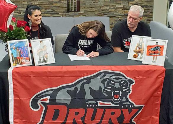 MAKING IT OFFICIAL - Sudan senior, Stevi Lockhart, signed her National Letter of Intent to play basketball for Drury University on Wednesday in the Sudan High School Library. She was joined my her Family, friends and coaches during the ceremony Wednesday morning. (Shown L-R): mom, Staci Lockhart, Stevi Lockhart and dad, Benny Lockhart. (Staff Photo by Derek Lopez)