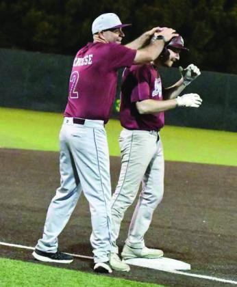 Littlefield Legends Coach Mitch McNeese celebrates a stand up triple with Chip Green on third base, during the Legends, 12- 11, victory over the Wildcats last Thursday in the second annual Alumni Game. (Staff Photo by Derek Lopez)