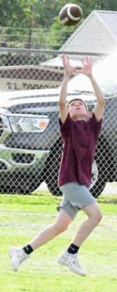 One of Littlefield JV’s receivers makes a catch in stride down the far side line for a catch, during their 7v7 match- up on Monday in Littlefield. (Staff Photo by Derek Lopez)