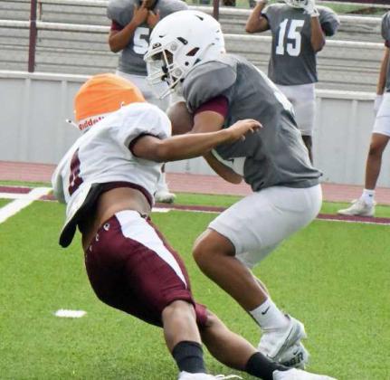 Littlefield’s defense gets into the backfield and makes a stop behind the line of scrimmage, during their intersquad scrimmage on Saturday at Wildcat Stadium. (Staff Photo by Derek Lopez)