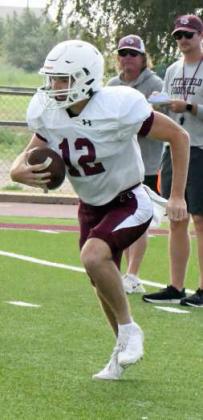 Littlefield senior quarterback, Chip Green, keeps the ball and takes off on a run to his left, during their intersquad scrimmage on Saturday at Wildcat Stadium. (Staff Photo by Derek Lopez)