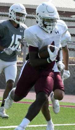 Littlefield’s Eizeah Coleman fields a kick return and looks for a crease to take it up field, during their intersquad scrimmage on Saturday at Wildcat Stadium. (Staff Photo by Derek Lopez)