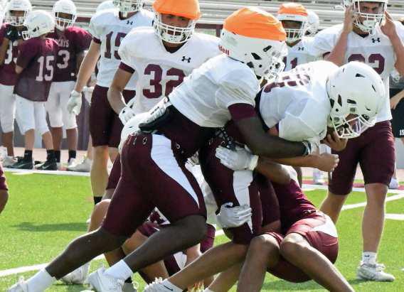 Littlefield’s defense makes a stop behind the line of scrimage, during their intersquad scrimmage on Saturday at Wildcat Stadium. (Staff Photo by Derek Lopez)