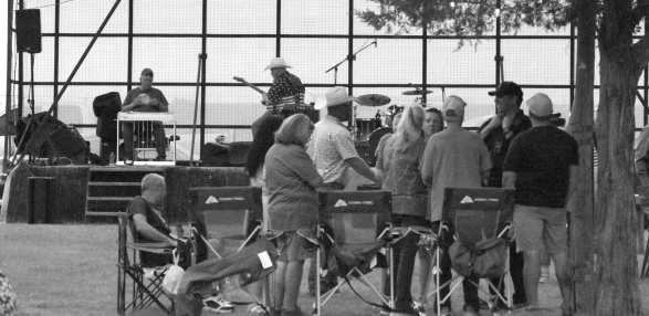 Families listen to live music by the Kelly Hastey Band during the Fourth of July celebration at Springlake Park. (Photos by Leon Szaniszlo)