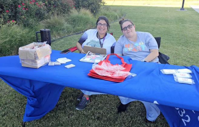 Jesi Telles and Katharine Quezada welcome people to the School Supply Splash Bash that took place on Monday at the Littlefield Aquatic Center, sponsored by the Chamber of Commerce. (Staff Photo by Derek Lopez)