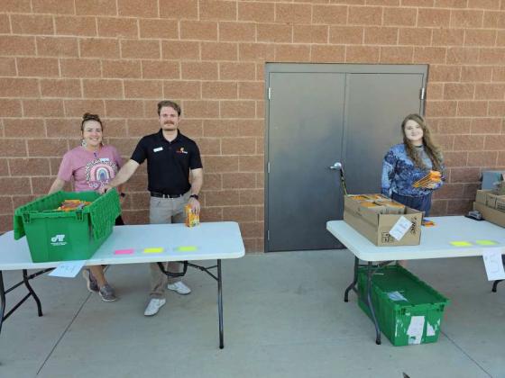 Jennifer McKinnon and Brett Brideweser of the Littlefield Chamber of Commerce and Zayleigh Sparks a volunteer from First Baptist Church helped hand out school supplies at the School Supply Splash Bash that took place on Monday at the Littlefield Aquatic Center, sponsored by the Chamber of Commerce.(Staff Photo by Derek Lopez)