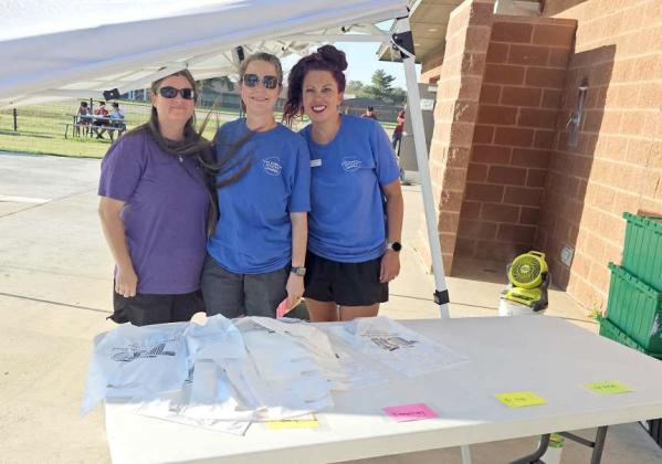 Johanna Dewbre, Traci Sparks and Melissa MacDonald handed out bags for people to collect school supplies at the School Supply Splash Bash that took place on Monday at the Littlefield Aquatic Center, sponsored by the Chamber of Commerce. (Staff Photo by Derek Lopez)