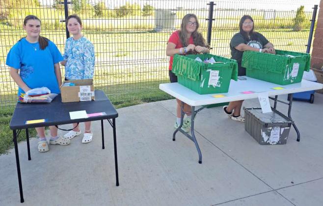 Jayda Dewbre, Zalyssa Sparks, Miley Dewbre and Arianna Dewbre, volunteers from First Baptist Church helped hand out school supplies at the School Supply Splash Bash that took place on Monday at the Littlefield Aquatic Center, sponsored by the Chamber of Commerce. (Staff Photo by Derek Lopez)