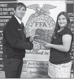 Tate Clark presents Rainey Hays with the Top Junior Showman award at the Littlefield FFA banquet on May 18, 2026.