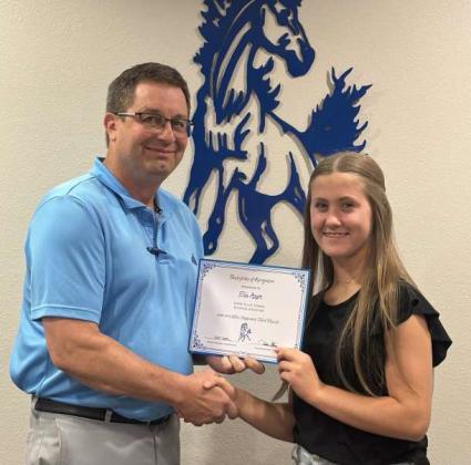 Tullie Struve, School Board President, left, awards Ella Azam, right, Olton Fillie Tennis Regional Qualifier. (Submitted Photo)