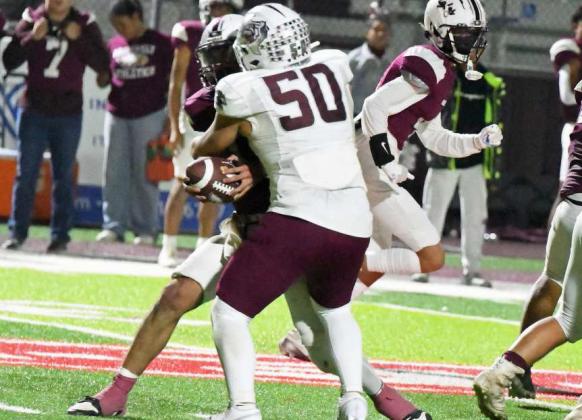 Littlefield senior defensive tackle, Marcquis Rosemond, wraps up the Roosevelt quarterback for a sack, during the fourth quarter of the Wildcats’ play-off clinching victory over the Eagles on Friday. (Staff Photo by Derek Lopez)