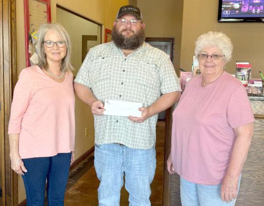 Evan Maxwell, center, presents Cheryl Sowder, left, and Kathy Dugan, right, with a donation for the Sudan Meals for Seniors program. (Submitted Photo)