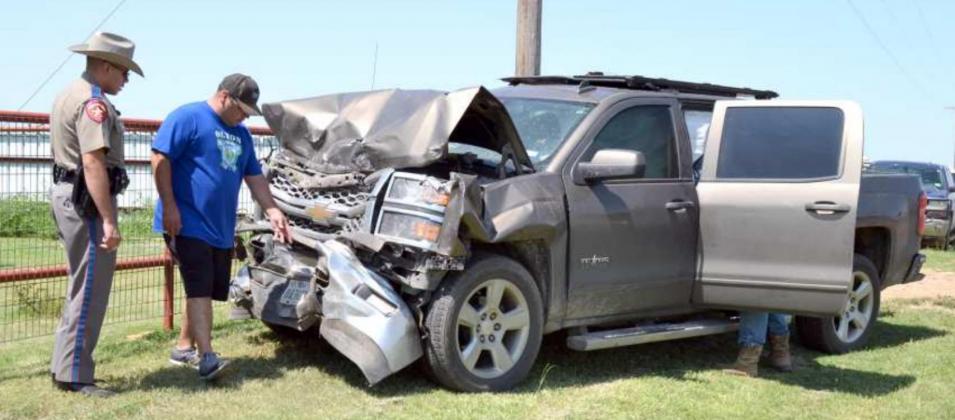 DPS TROOPER LOOKS AT CHEVROLET PICKUP’S SMASHED FRONT