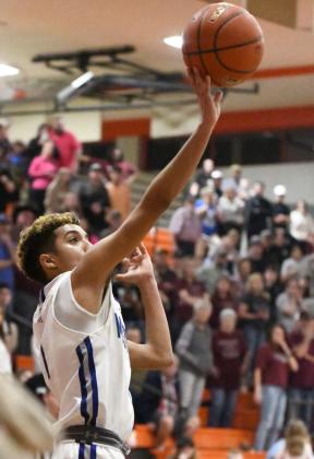 Olton sophomore, Sebastian Sparkman, races down the court with 10 seconds to play in overtime and drops in a floater from the right wing as time expires, sending the Mustangs to the 2A Regional Tournament, taking down the Clarendon Broncos, 63-62, at Caprock High School on Tuesday. (Staff Photo by Derek Lopez)