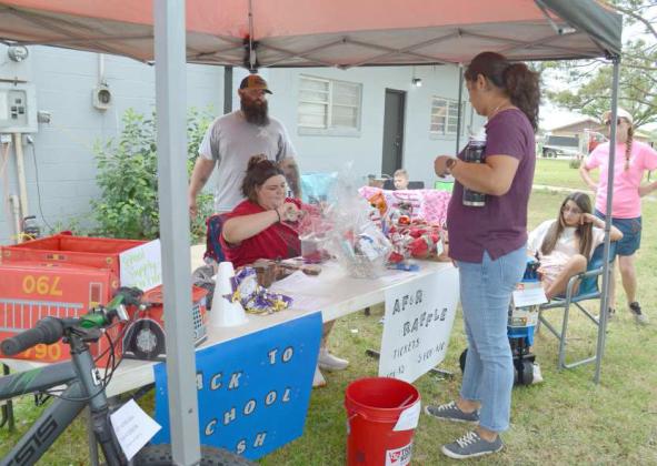 Two members of the Anton Volunteer Fire and Rescue, Tony Goley and Ricka Goley, give tickets for the Fire and Rescue raffle that helped raise funds for the fire department. (Photo by Samantha Pontius)