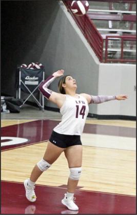 Littlefield’s Gabby Medina sends a serve over the net, during the first set of the Lady Cats’ district match-up with Shallowater on Tuesday at Wildcat Gym. (Staff Photo by Derek Lopez)