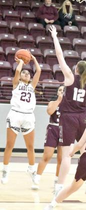 PULLING UP FOR TWO-Littlefield senior, Geyah Garza (23), pulls up for a mid-range jumper from the right baseline over the outstretched hands of a Hereford defender, during the first half of the Lady Cats’, 52-40, loss to the Lady Whitefaces on Tuesday at Wildcat Gym. (Staff Photo by Derek Lopez)