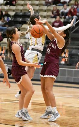 Littlefield’s Danica Jouett (24) blocks the shot of Lamesa’s Reagan Derington (11), as Littlefield’s Cali Saldana (21), gathers the lose ball to take it the other day, during the first half of the Lady Cats road victory over the Lady Tornadoes on Tuesday. (Staff Photo by Derek Lopez)